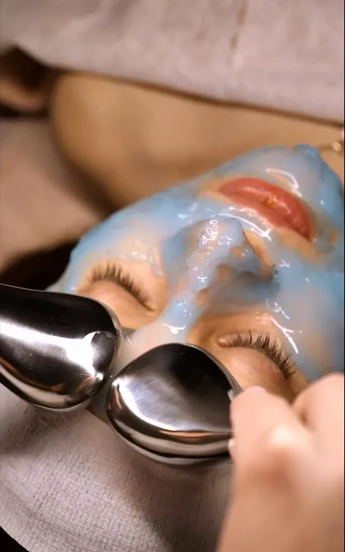 A client receiving a professional blue mask treatment