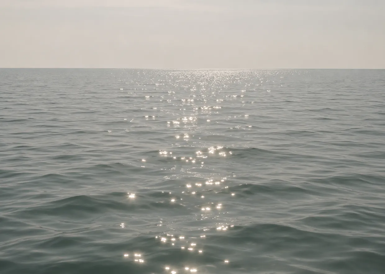 Sunlight reflecting across a calm ocean horizon