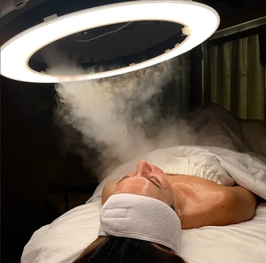 A client receiving a steam facial treatment